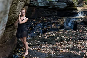 fashion model black dress waterfall portrait